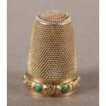 A VICTORIAN THIMBLE in 9ct gold, the circular turquoise cabochon stones collet set within a