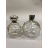 TWO GLOBULAR PLAIN CUT GLASS SCENT BOTTLES, one with silver screw top, London, c.1925, 11.5cm