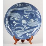 A CHINESE BLUE AND WHITE CHARGER, 19th century, circular, painted with dragons chasing the flaming