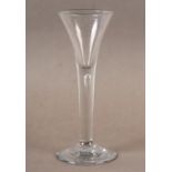 AN 18TH CENTURY WINE GLASS, the tapered trumpet bowl drawn into a plain stem with a tear on