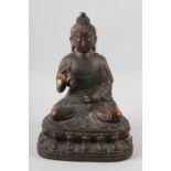 A GILDED BRONZE FIGURE OF BUDDHA, in vitarka mudra pose, sitting on a double lotus plinth, 34cm high