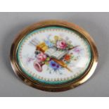 A GEORGE V PAINTED PORCELAIN BROOCH BY W E MOSLEY OF DERBY, the oval polychrome floral arts