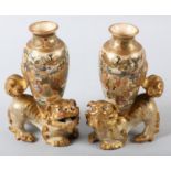 A PAIR OF JAPANESE POTTERY VASES, MEIJI PERIOD, modelled as a temple lion surmounted with a vase
