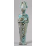 AN EGYPTIAN FAIENCE SHABTI, turquoise glaze with hieroglyphics, 18.5cm long
