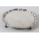 A GEORGE II SILVER SALVER, Paul Crespin, London 1731, circular with pie crust rim on four knurled