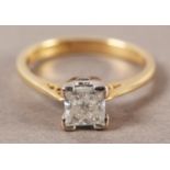 A SINGLE STONE DIAMOND RING in 18ct yellow and white gold, the Princess cut stone set in a tapered