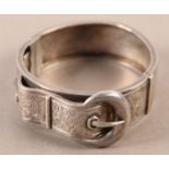 A VICTORIAN STIFF HINGED BANGLE IN SILVER applied to the front with a foliate engraved belt and