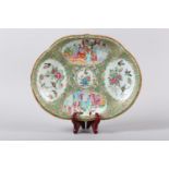 A 19TH CENTURY CHINESE FAMILLE ROSE DISH OF OVAL SHAPED FORM, painted with figures on a garden