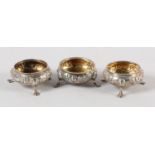 A SET OF THREE VICTORIAN SILVER OPEN SALTS, circular, beaded rims, embossed with flowers and