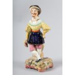 A 19TH CENTURY STAFFORDSHIRE POTTERY FIGURE OF AN ACTOR, possibly Garrick, standing with a