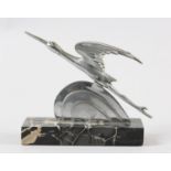 AN ART DECO CHROMED BRONZE STYLISED FIGURE OF AN EGRET IN FLIGHT AND CLOUD, on a black marble