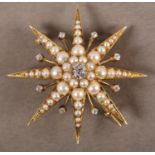 A VICTORIAN DIAMOND AND PEARL STAR BROOCH in 18ct gold, the principal Old European cut diamond