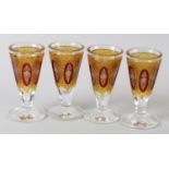 A SET OF FOUR 19TH CENTURY BOHEMIAN DRINKING GLASSES, the hobnail cut funnel bowls in yellow with