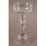 A MID 18TH CENTURY SWEETMEAT GLASS, of unusually small size the plain ogee bowl with a flared rim,