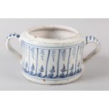 A DUTCH DELFTWARE BLUE AND WHITE POSSET POT, painted with vertical panels filled with grass and