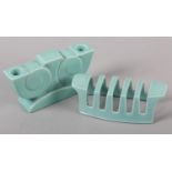 A POOLE POTTERY TWIN CANDLESTAND and a four bar toast rack in pale turquoise glaze, c.1938,