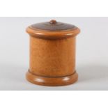 A 19TH CENTURY LIGNUM VITAE turned string box of drum form, 13.5cm diameter x 16cm high