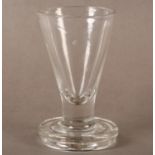 A TOASTMASTER OR FIRING GLASS with a thick base, the plain bowl of conical form a circular base,