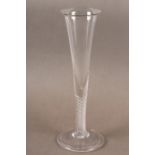 A CHAMPAGNE WINE GLASS, the trumpet bowl seaming into a multi twist stem on a conical and folded