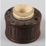 A LATE 18TH/EARLY 19TH CENTURY TREEN INKWELL, of drum shape carved with vertical bands and milled