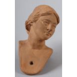 A TERRACOTTA HEAD OF A LADY 'MARIA' with coiffured hair, from a nativity set and made by the