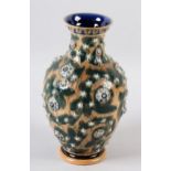 A DOULTON LAMBETH STONEWARE VASE BY ARTHUR BARLOW, the buff glazed ovoid body incised and applied