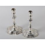 A PAIR OF GEORGE II CAST SILVER CANDLESTICKS, James Gould, London 1733, ringed sconce on a fluted