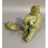 Inuit Carving - Seal Hunter with Seal by Omagaiuk Tikivik c.1970, distinctive browns and green