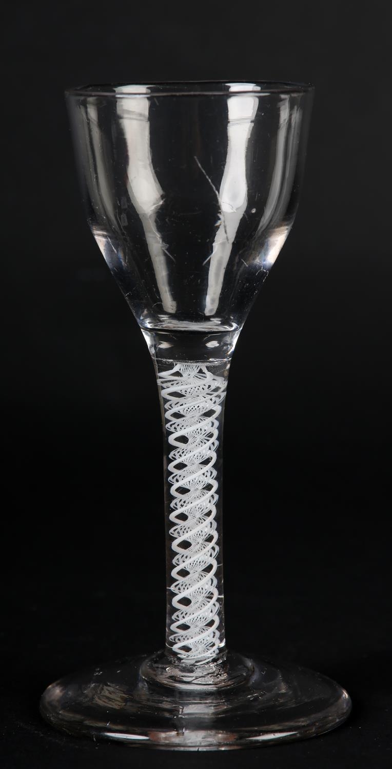 A MID 18TH CENTURY WINE GLASS with ogee bowl on double series opaque twist stem and conical foot,