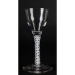 A MID 18TH CENTURY WINE GLASS with ogee bowl on double series opaque twist stem and conical foot,