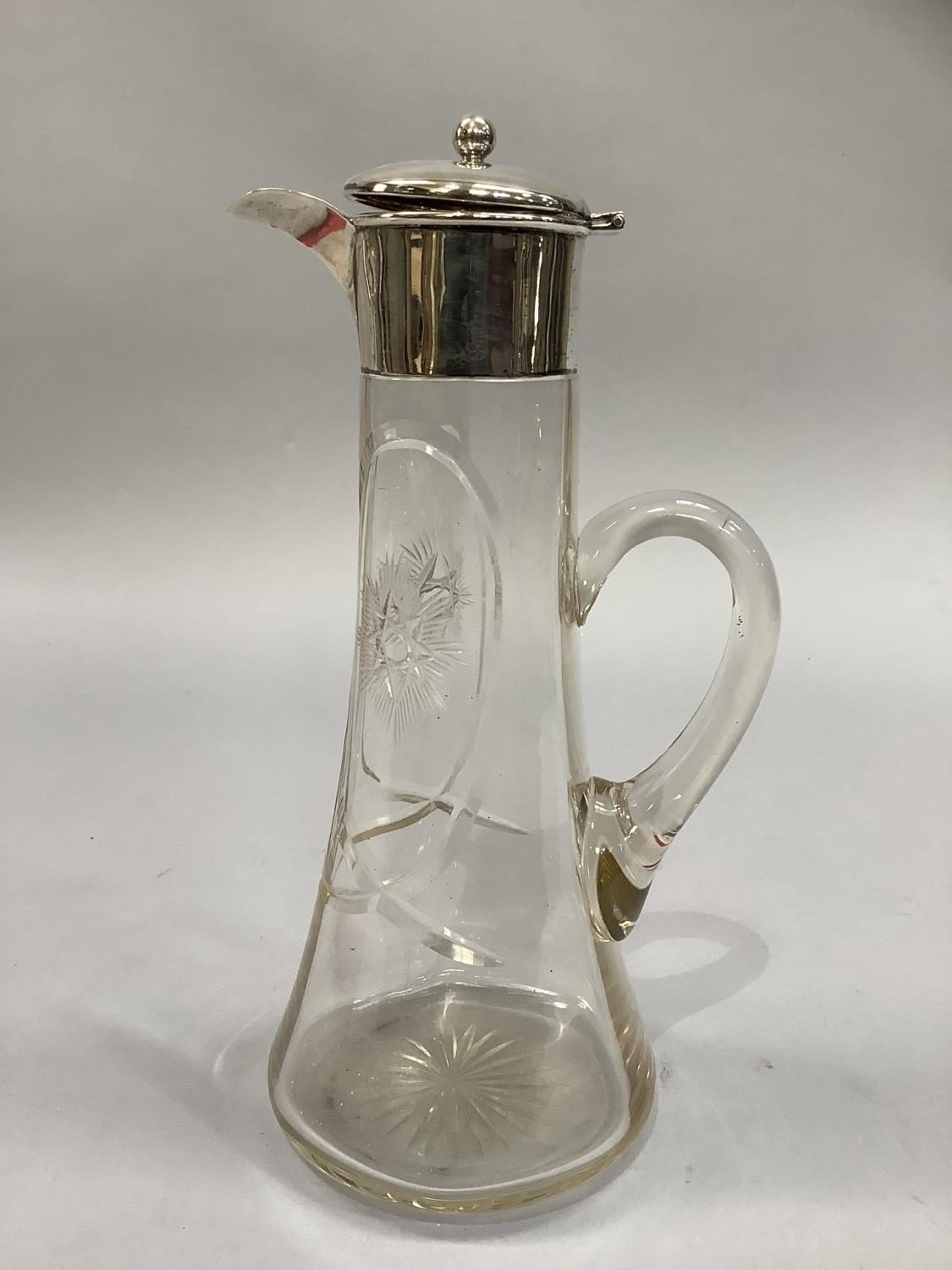 An Edwardian star etched silver mounted cut glass claret jug of tapered cylindrical form,