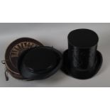 Two French collapsing silk gentleman’s opera hats, or chapeaux claques, the first in its