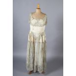A French silver lamé evening dress, the bodice cream, the lamé formed as a collar and then from
