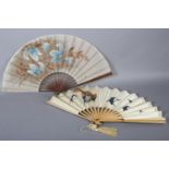 A good late 1890’s wood fan, the cream silk satin leaf panted with birds returning to a nest in