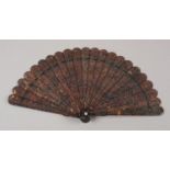 A fine and detailed Chinese carved tortoiseshell brisé fan circa 1840’s, the 21 sticks and 2 guards,