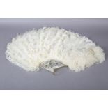 A good late 19th century white ostrich feather fan, the monture of slightly pink white mother of