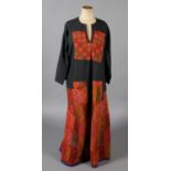 A middle eastern robe in black with panels of vibrant embroidery