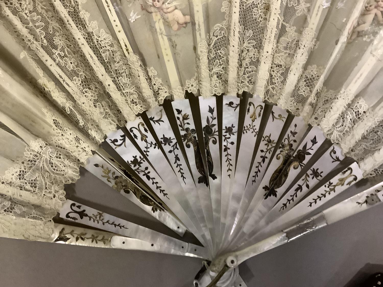 Fans: one late 19th century with gilded mother of pearl monture and painted gauze leaf; a smaller - Image 4 of 5