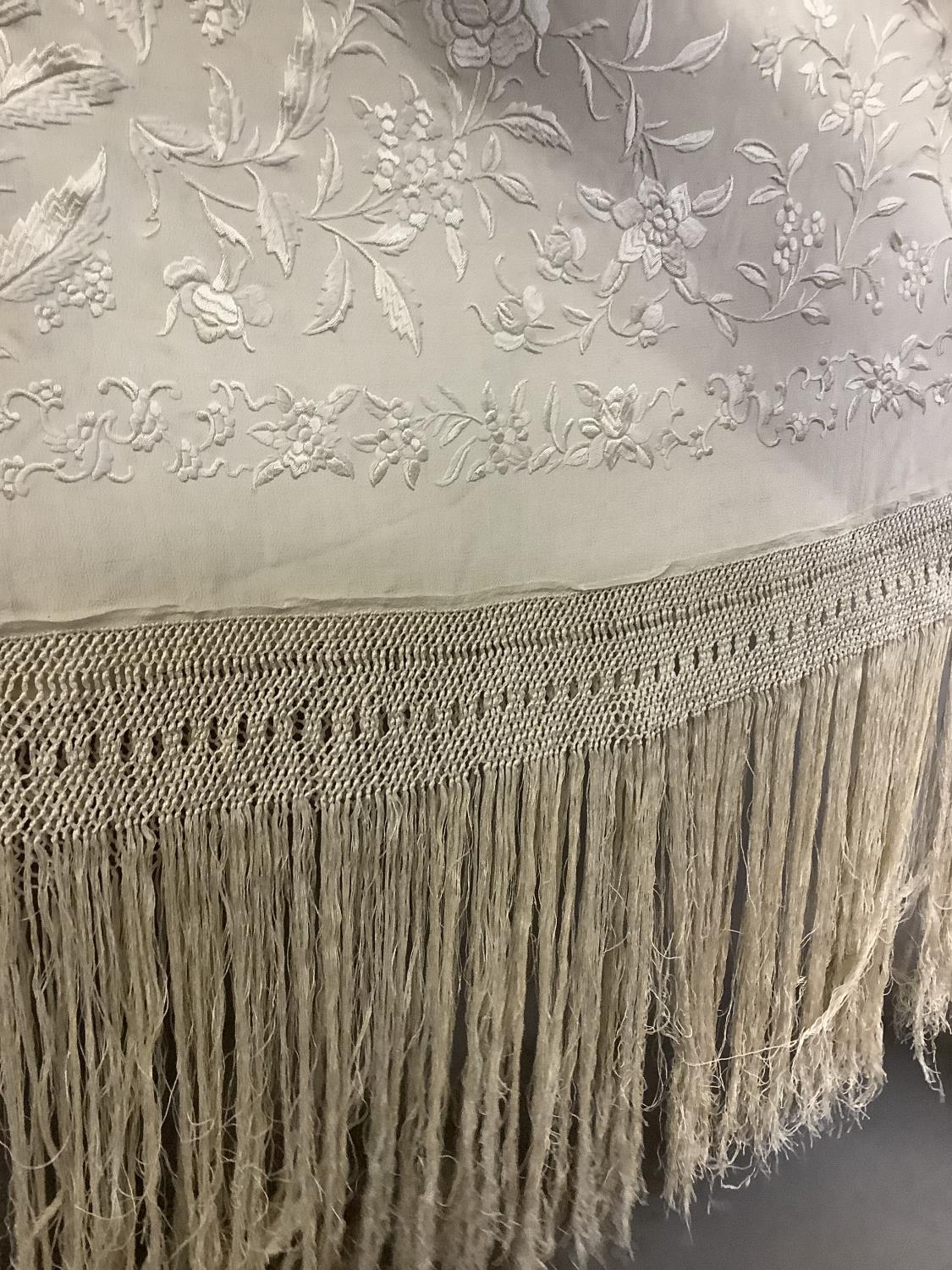 An embroidered silk Canton shawl, cream on cream, with macramé fringe, each corner with a large - Image 3 of 6