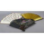 Three 20th century Oriental fans, with wood montures and paper leaves, the first depicting a