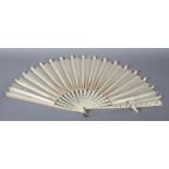 A large late 1890’s fan with unusual cream silk ribbon work detail applied to spotted net, mounted à