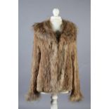A stylish tan fur jacket, hip length, labelled Gil Bret, the collar, front and long sleeves