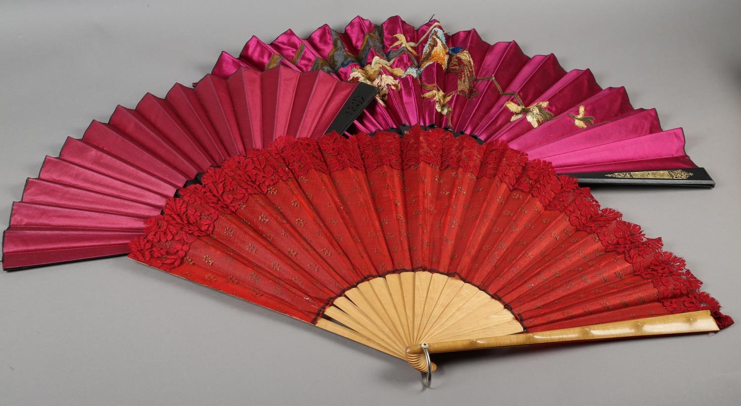 Three late 19th century fans, all with wood montures, with decorative gilding, the cerise silk leaf,