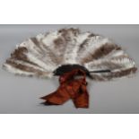 A good female ostrich feather fan, the monture of tortoiseshell, the loop fitted with a n