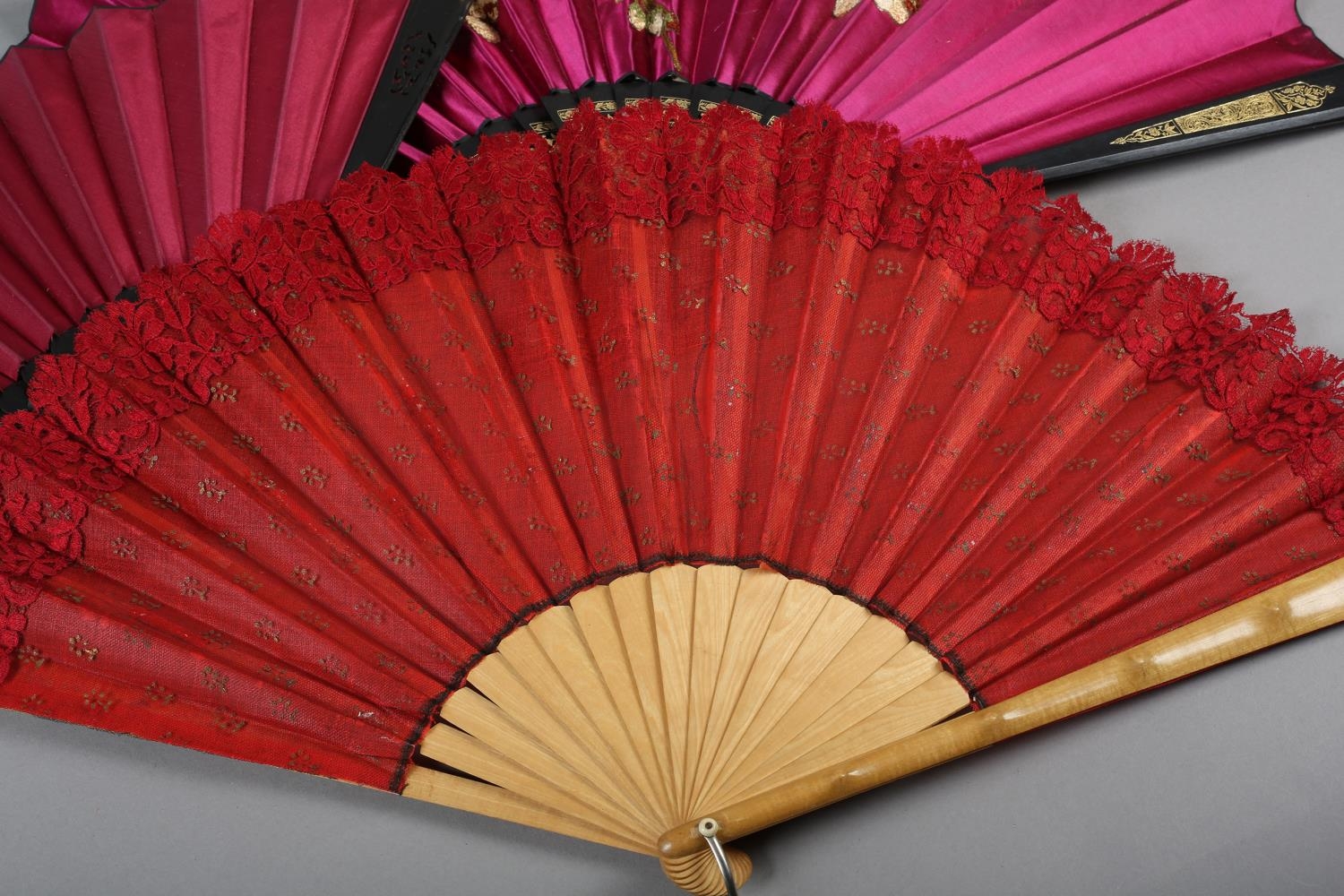 Three late 19th century fans, all with wood montures, with decorative gilding, the cerise silk leaf, - Image 2 of 6