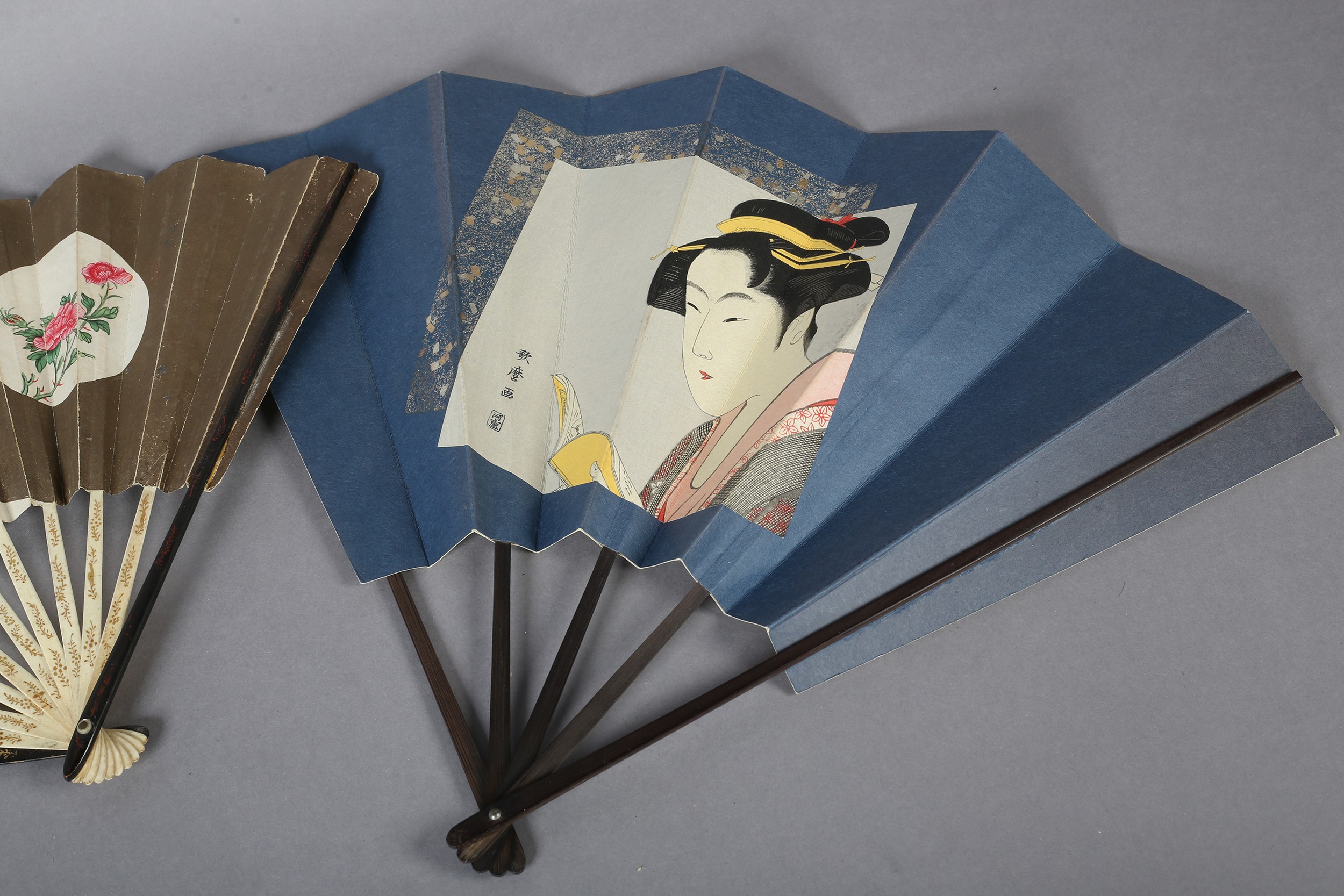 Two large Japanese fans, the first with a central portrait of a geisha, with hair accessories and - Image 2 of 4