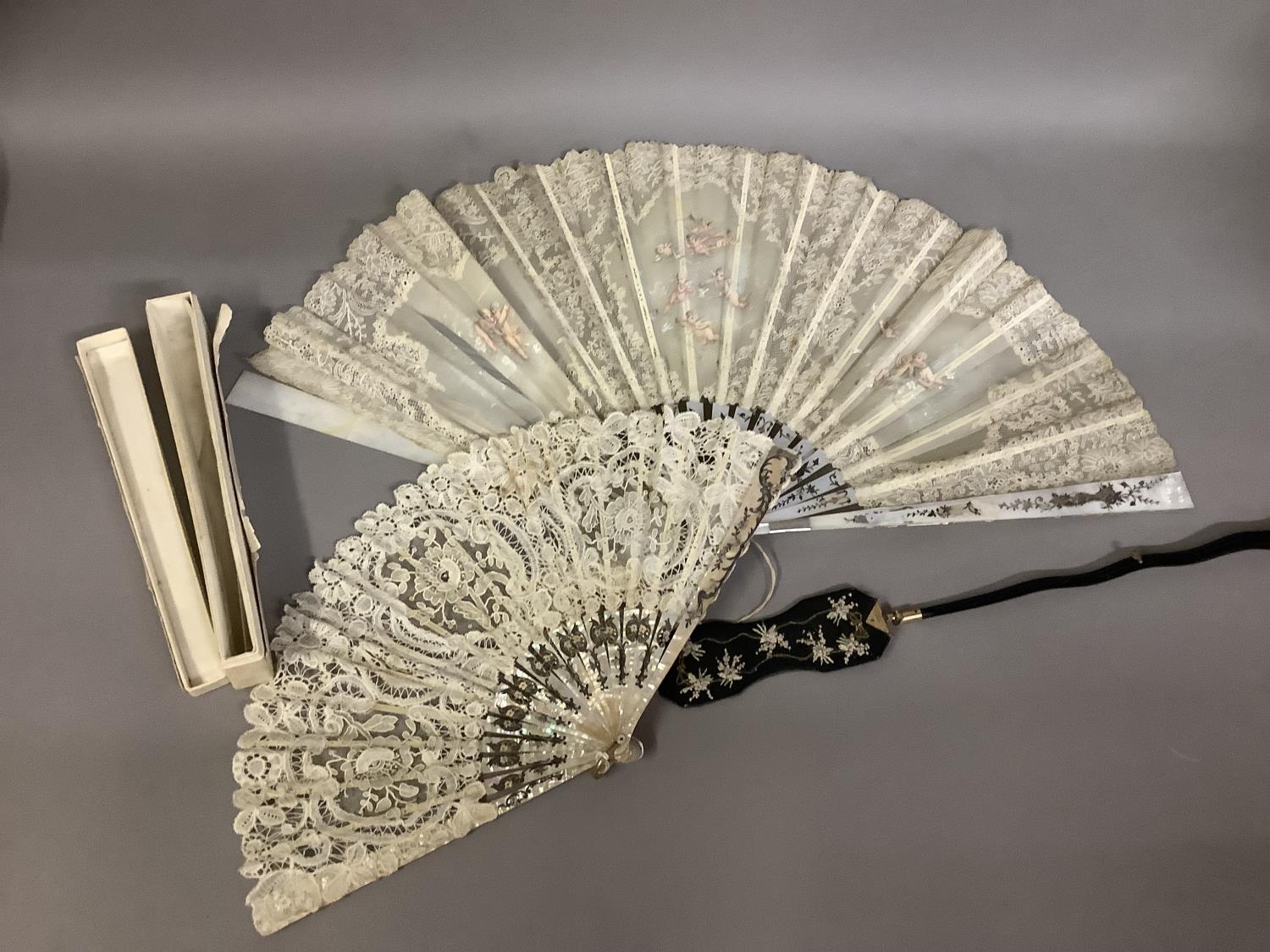 Fans: one late 19th century with gilded mother of pearl monture and painted gauze leaf; a smaller