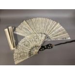 Fans: one late 19th century with gilded mother of pearl monture and painted gauze leaf; a smaller