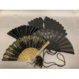A selection of 19th century fans: A palmette fan or Jenny Lind, the wood sticks dyed black, and