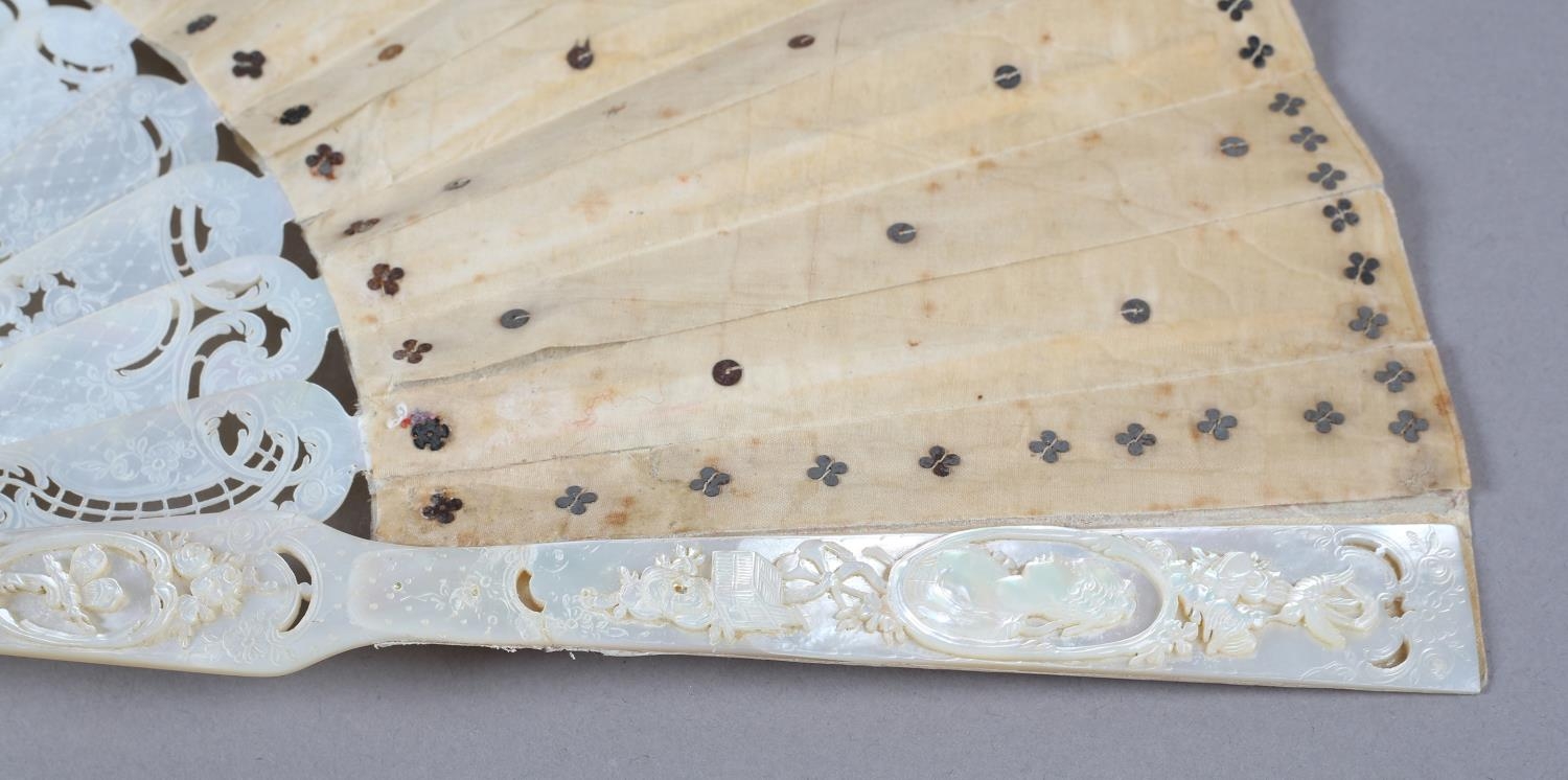 A c.1880’s mother of pearl fan with very elaborate carving, the guards pierced then applied with - Image 4 of 6